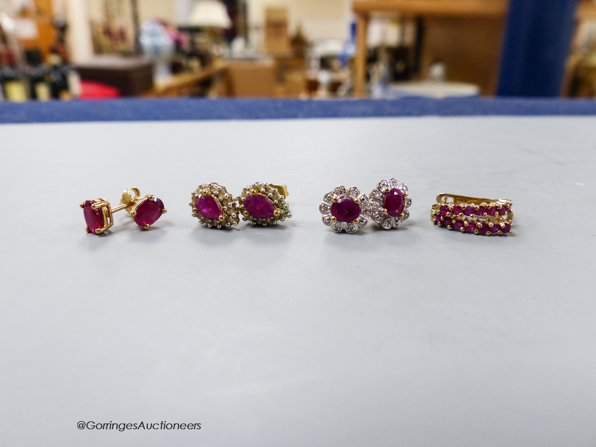 Four assorted modern pair of 9ct ruby or ruby and diamond set ear studs, gross 6.2 grams